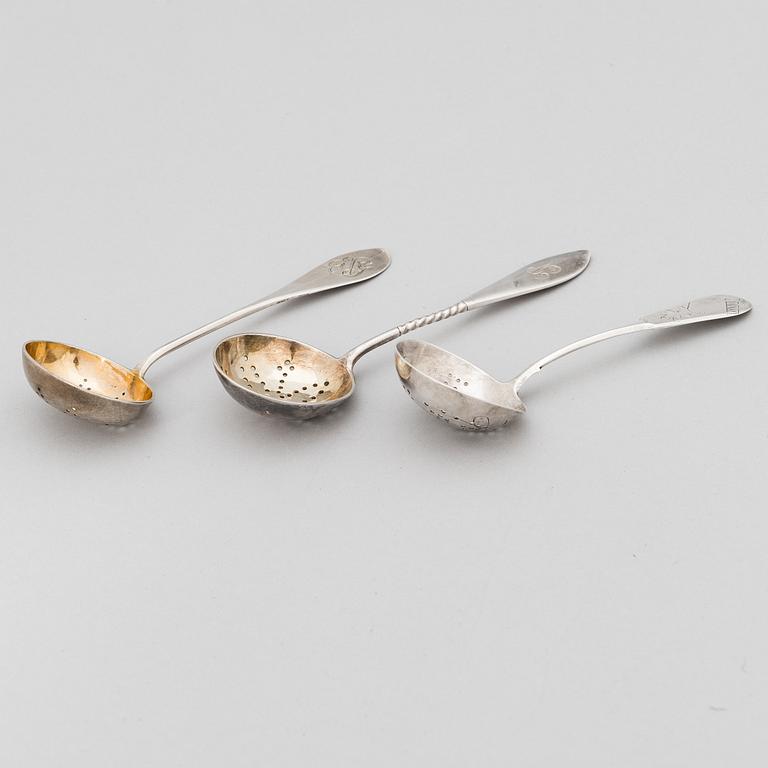 Three Russian silver tea strainer/ sprinkle spoons, late 19th to early 20th century.