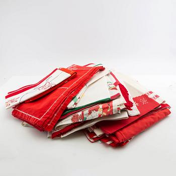 A collection of smaller Christmas tablecloths, runners, wall hangings, curtains, and Christmas tree skirts, 32 pcs, 20th century.