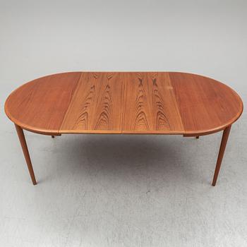 A 1960s teak veneered dining table.