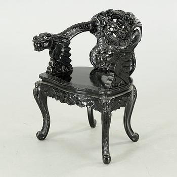 A Japanese 20th century arm chair.