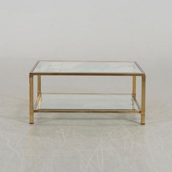 A GLASS TOP COFFEE TABLE.