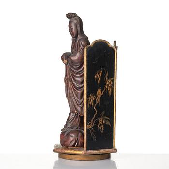 A wooden sculpture of Guanyin with metal inlay, Qing dynasty.