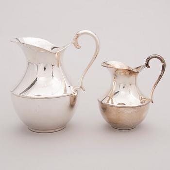 Two late 20th century white metal tankards.