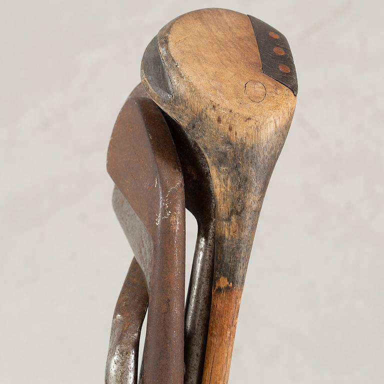 Five early 20th century golf clubs and bag.