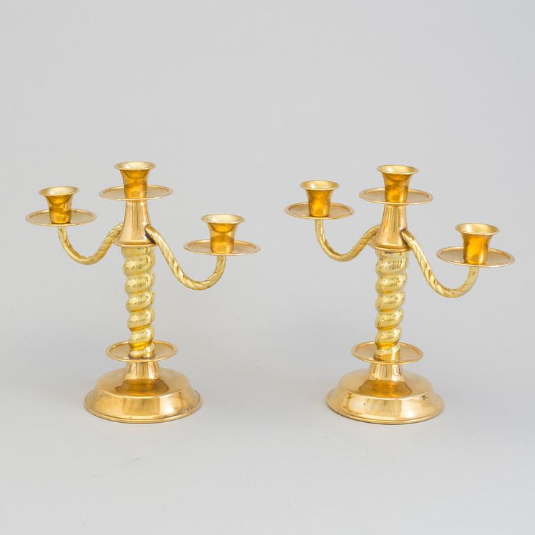 a pair of brass candelabras by Gottfrid Carlsson Eskilstuna.