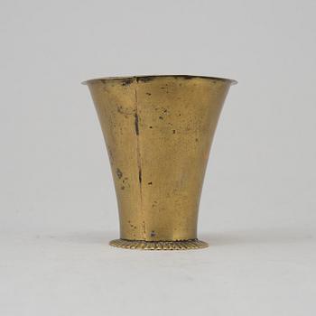 An 18th century brass beaker.