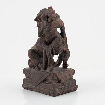 A stone sculpture of a mythical creature and four textile fragments, Qing dynasty.
