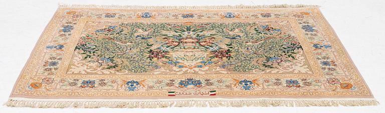 An Esfahan rug, part silk, figural, signed, c. 108 x 155 cm.