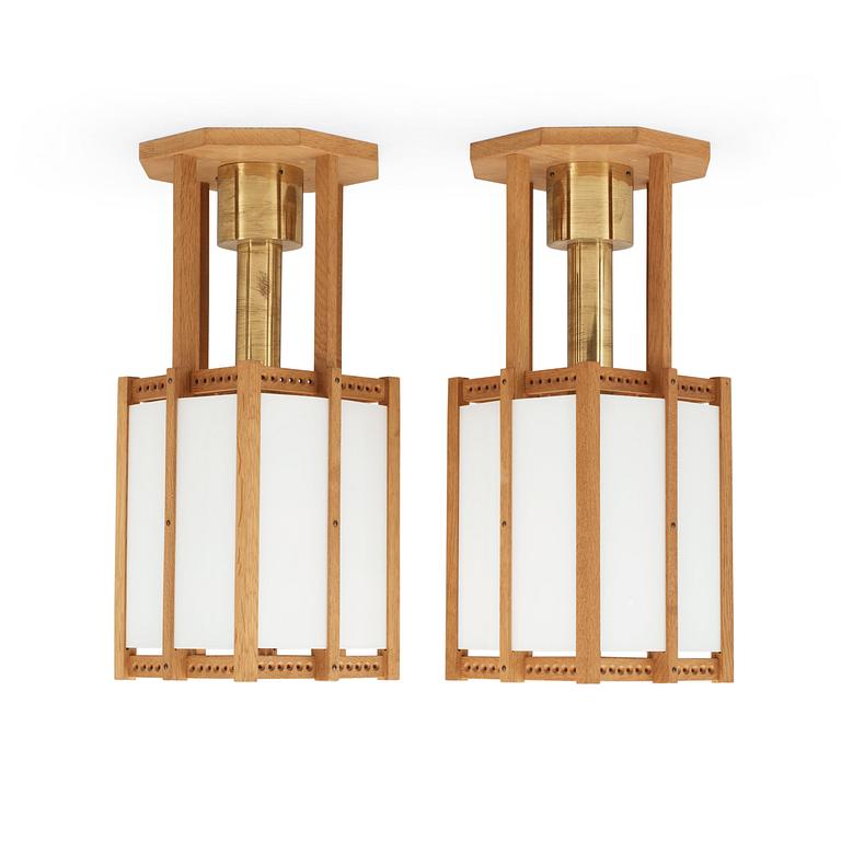 A pair of John Kandell oak, brass and opaque glass celing lamps, Sweden 1950's.