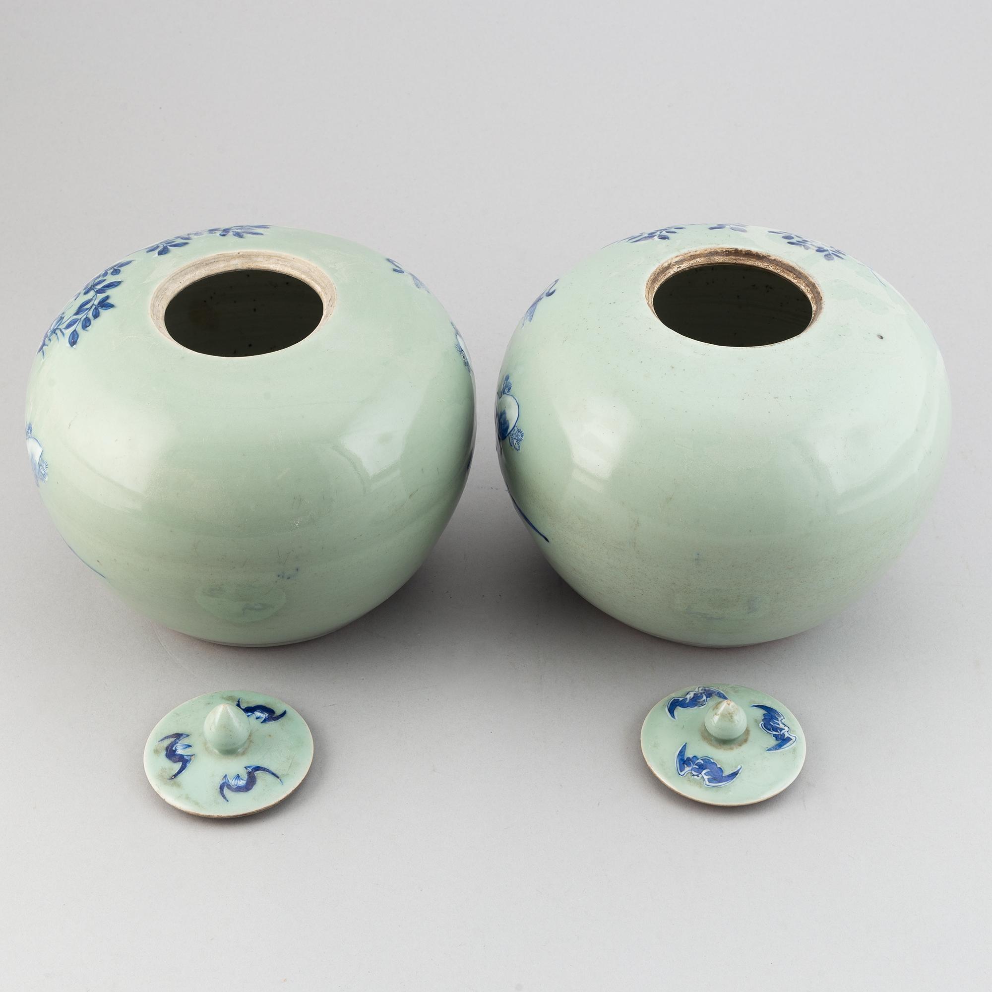 A pair of Chinese celadon glazed and blue and white jars with covers, 20th century.