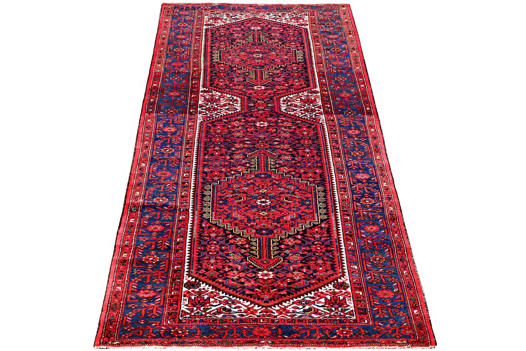 A Hosseinabad carpet, c. 391 x 135 cm.