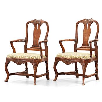 36. A pair of rococo arm chairs, later part of the 18th century.