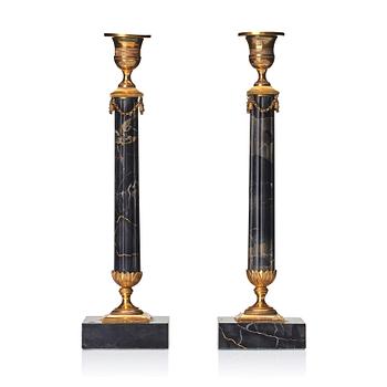 A pair of late Gustavian Portor marble candlesticks, late 18th century.