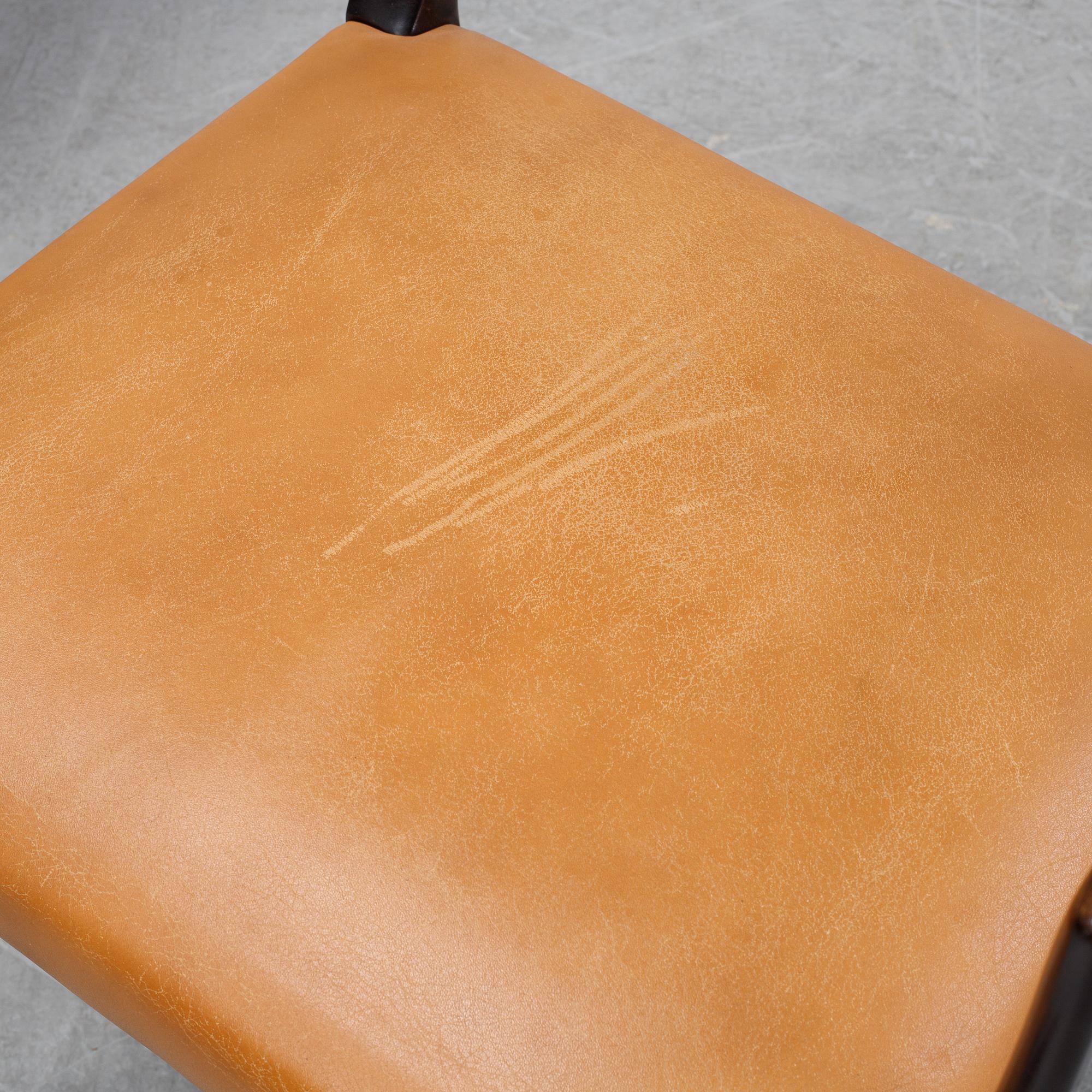 A set of four black stained beech tree arm chairs with leather upholstery, second half of the 20th century.