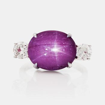 A cabochon cut star ruby and brilliant cut diamond ring. Diamonds total carat weight 1.20 ct.