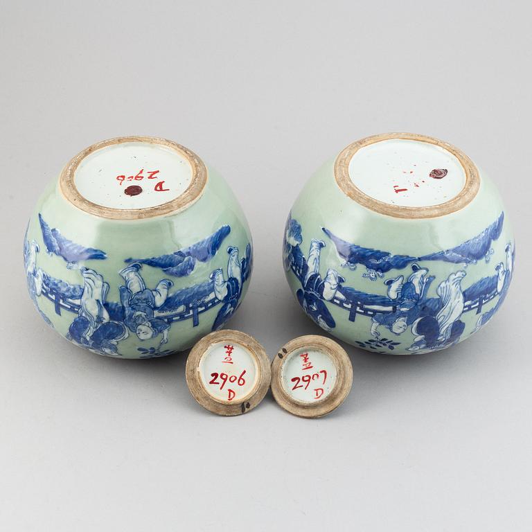 A pair of Chinese celadon glazed and blue and white jars with covers, 20th century.