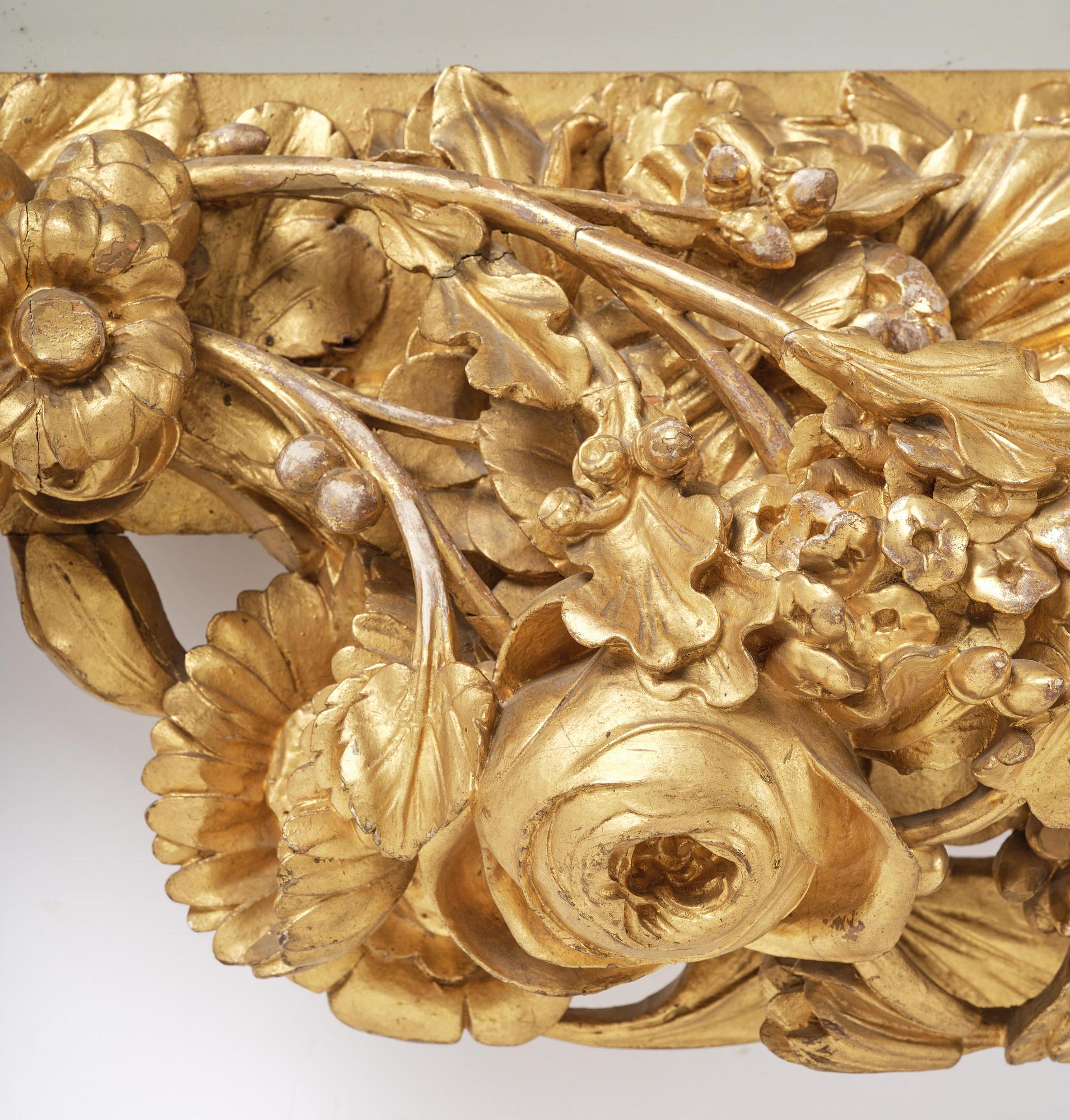 A presumably Dutch Louis XIV carved giltwood frame with mirror glass, in the style of Jean Le Pautre, late 17th century.