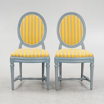 A painted sofa, table, a pair of chairs, a pair of armchairs, a pair of stools, Gustavian style, 20th Century.
