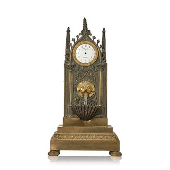 150. An English neo-Gothic patinated and ormolu mechanical mantel clock, ca 1820.