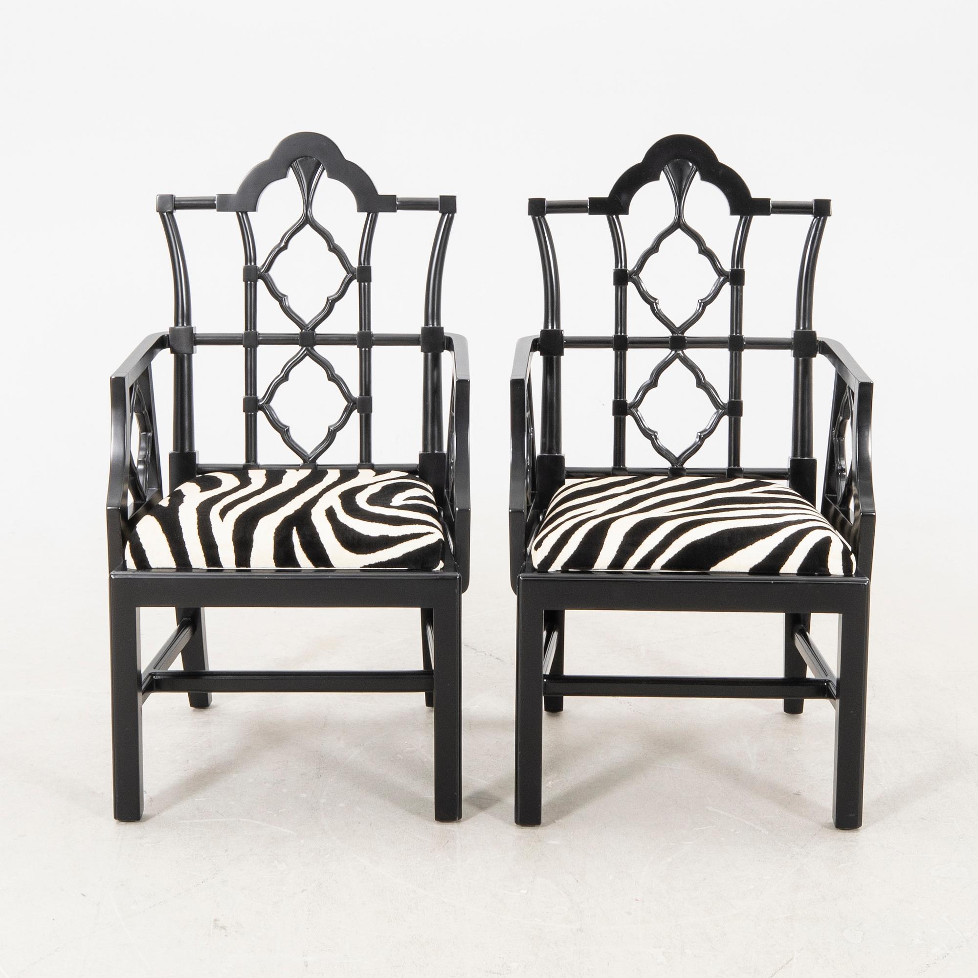 A pair of modern Eichholtz armchairs.