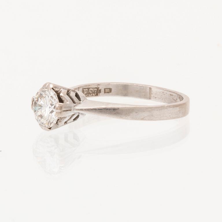An 18K white gold solitaire ring set with a round brilliant cut diamond.