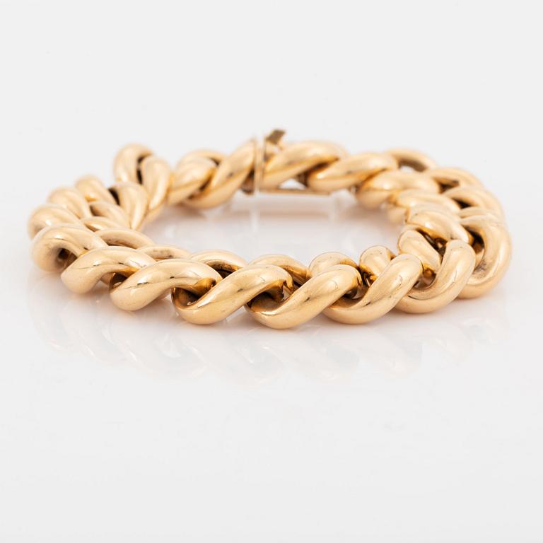 An 18K gold bracelet.