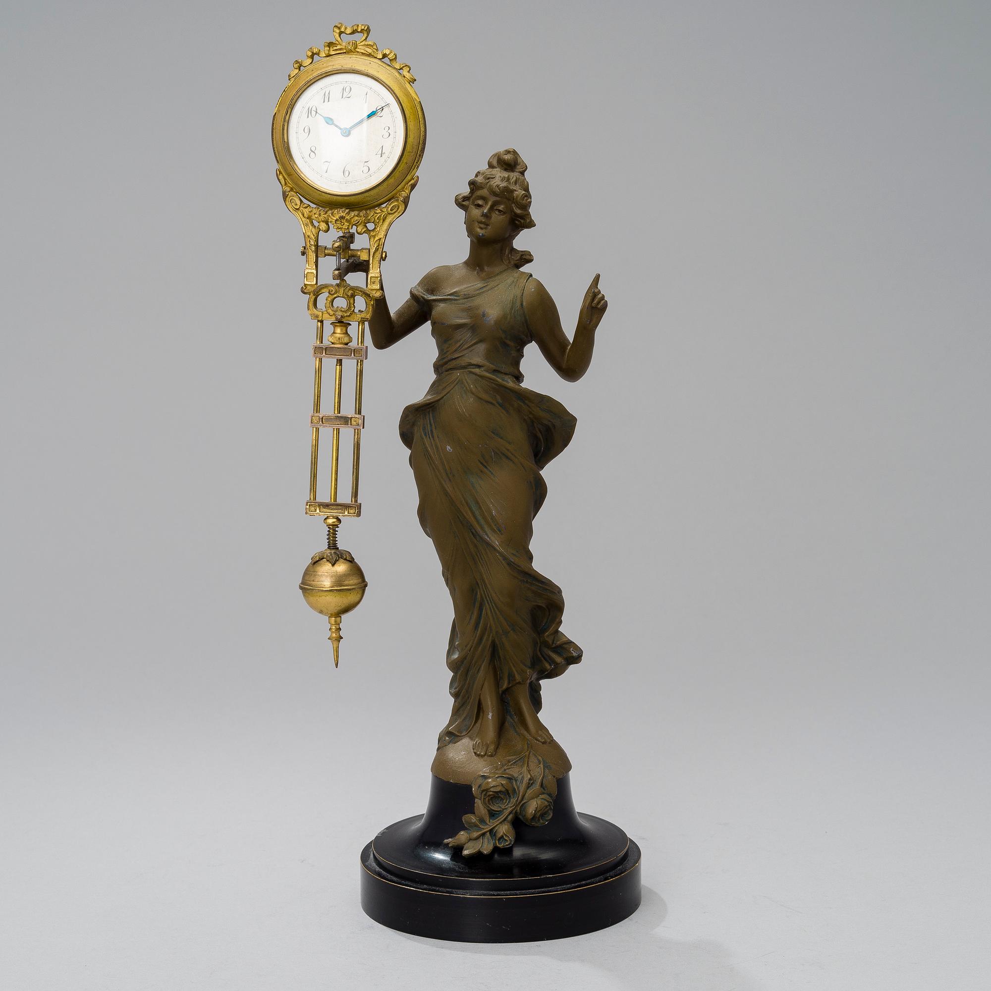 A 1930s Junghans swinger clock with girl sculpture.