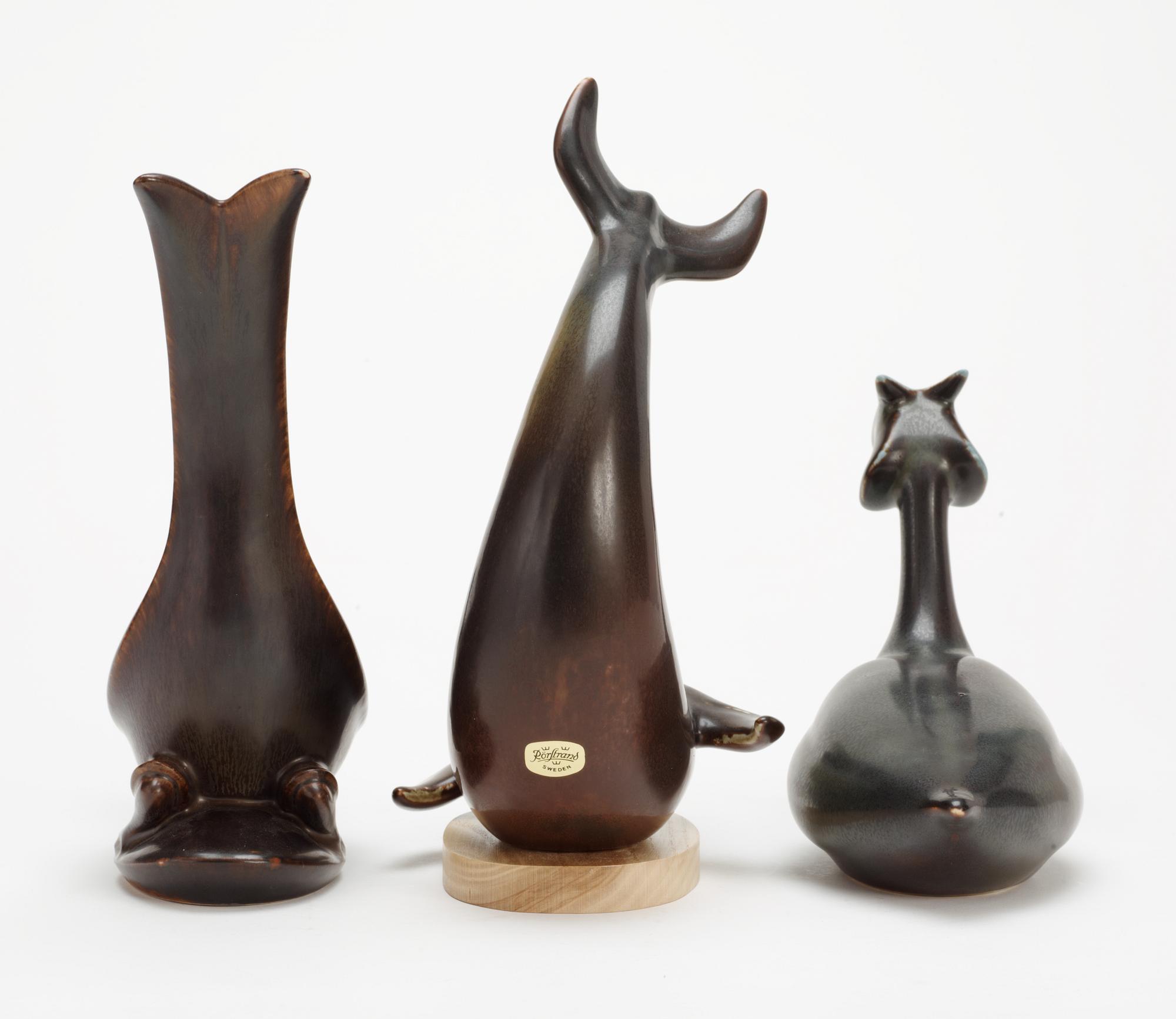 Three Gunnar Nylund stoneware figures, a dolphin, a pheasant and a great crested grebe, Rörstrand.
