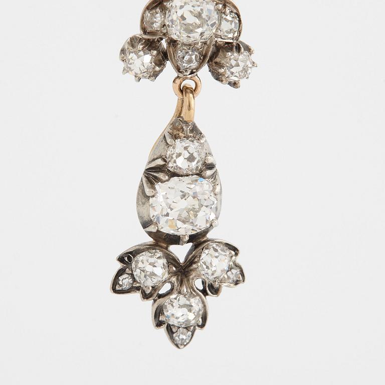 A 14K gold and silver brooch set with old-cut diamonds.