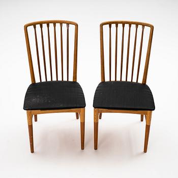 A pair of Scandinavian Mid Century Modern teak, oak and elm chairs.