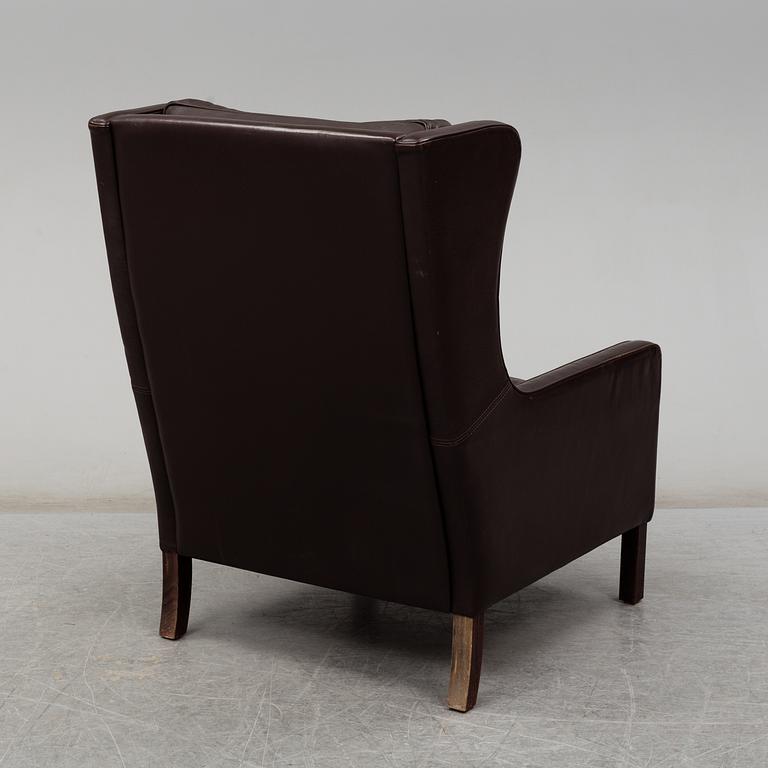 A leather covered 'Lulu' wing-chair from Stouby, Denmark, second half of the 20th Century.