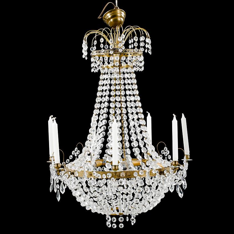 A 20th century chandelier in the Empire style. Height ca 96 cm.