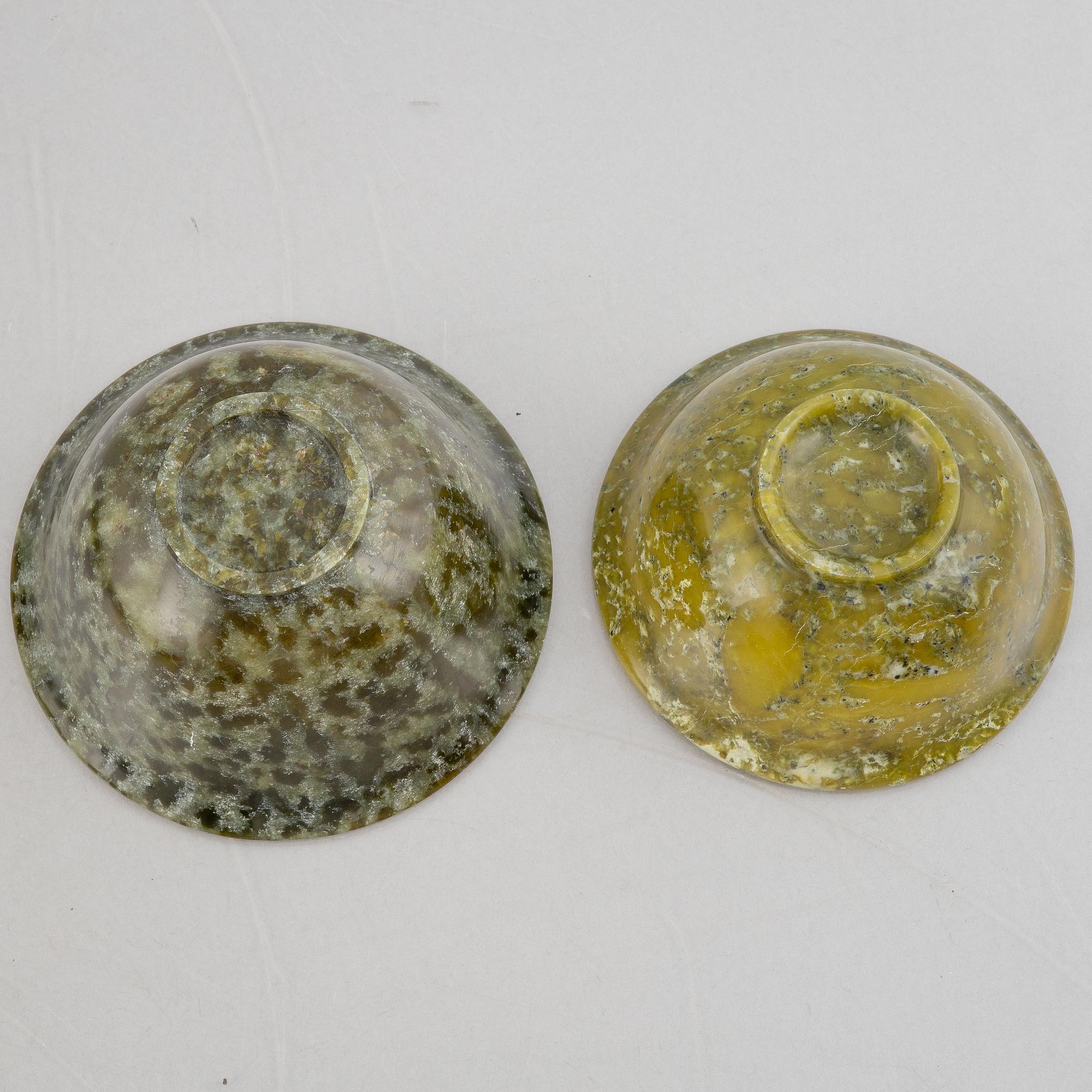 A group of ten Chinese spinach green stone bowls.