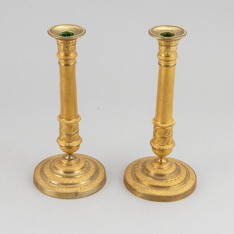 An early 19th Century pair of bronze empire candle sticks.