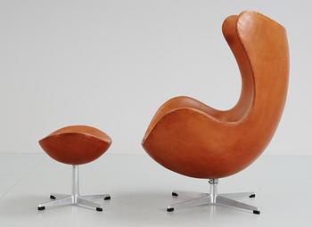 An Arne Jacobsen brown leather 'Egg' chair and ottoman, Fritz Hansen, Denmark 1963.