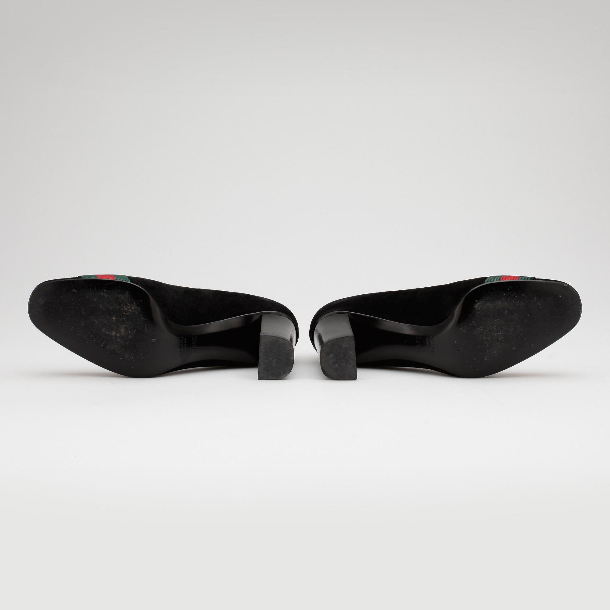 GUCCI, a pair of black suede pumps.
