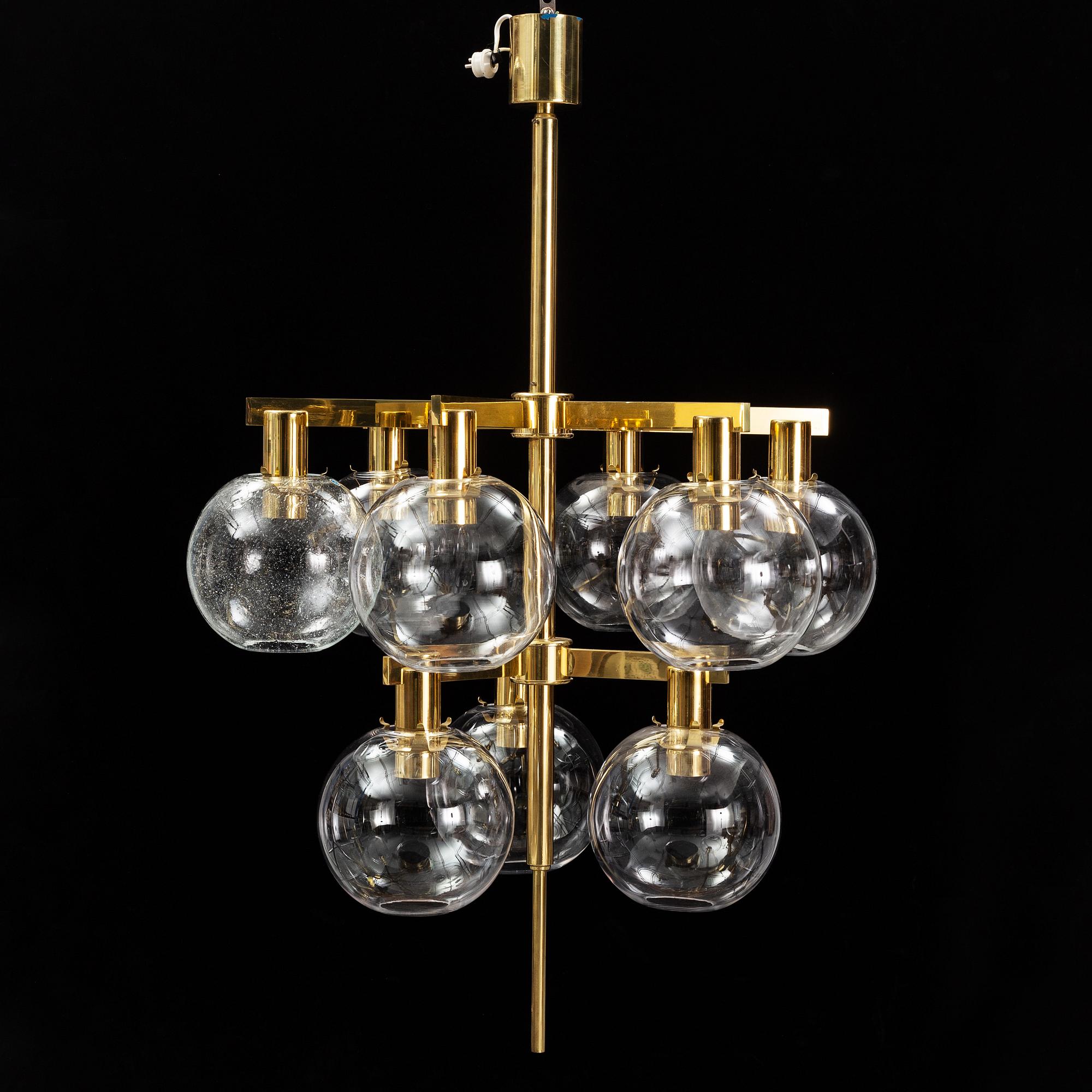 A brass chandelier with glass globes by Hans Agne Jakobsson, Markaryd.