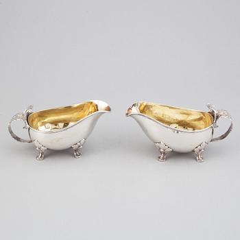 A pair of rococo-style parcel-gilt silver sauce-boats, mark of CGH, Stockholm 1945-1947.