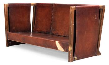 An Axel Einar Hjorth 'Funkis' brown leather and stained wood sofa, Nordiska Kompaniet, Sweden 1930's.