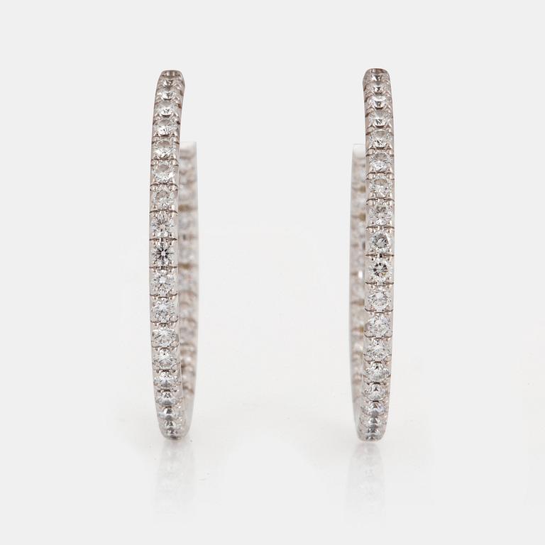 A pair of Tiffany "Metro" 18K white gold hoops set with round brilliant-cut diamonds.