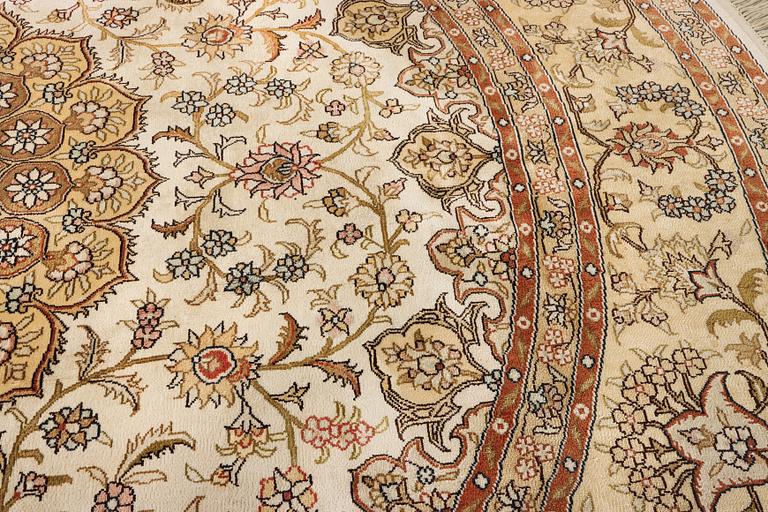 An oriental silk rug, diameter c. 216 cm.
