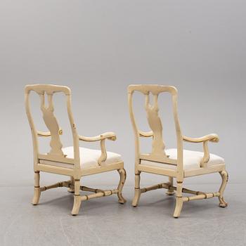 A 19th century pair of late baroque style armchairs.