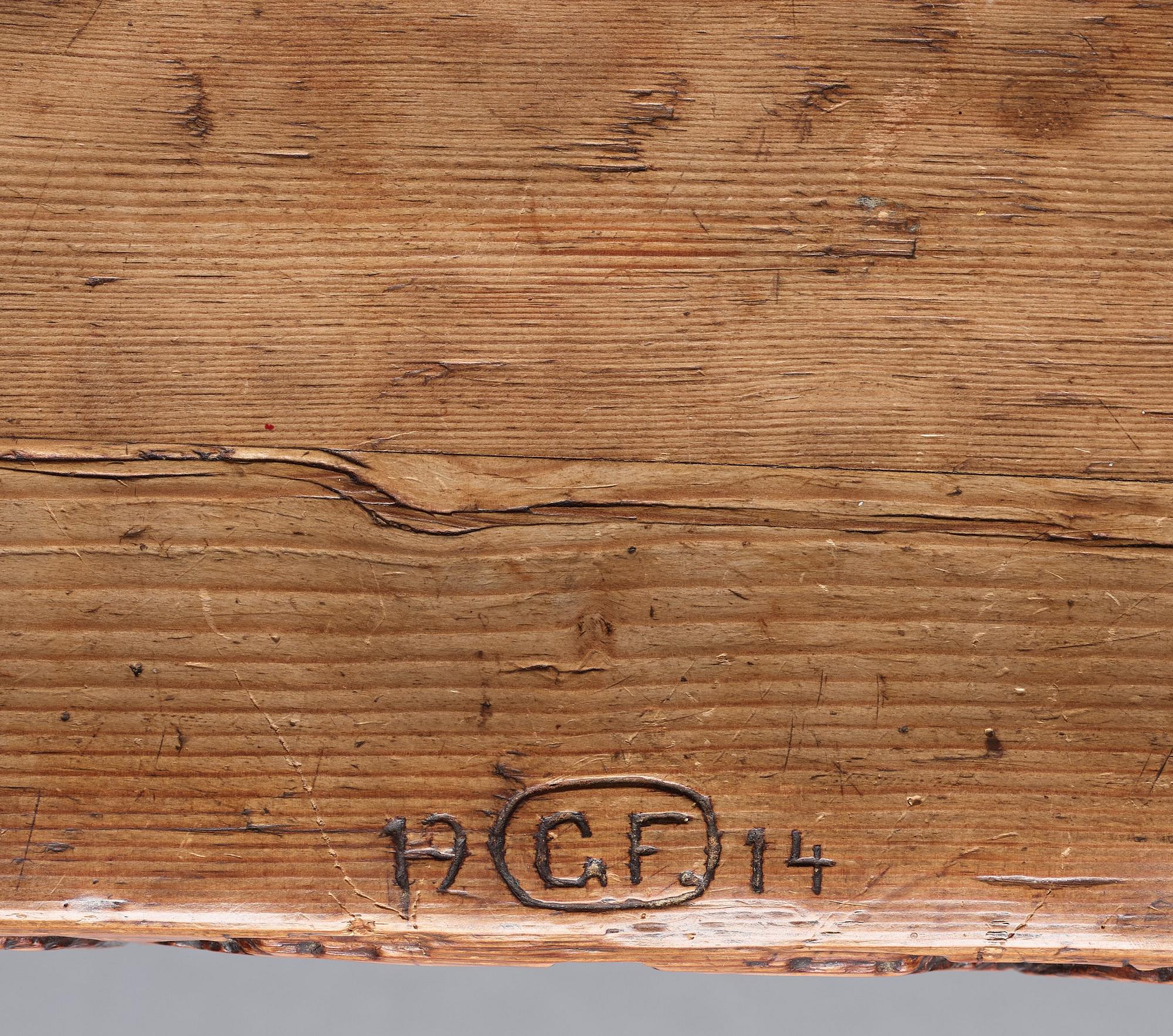 Gustaf Fjaestad, an Art Nouveau carved pine table, Arvika Sweden 1914, a double to the table in the Thiel Collection,