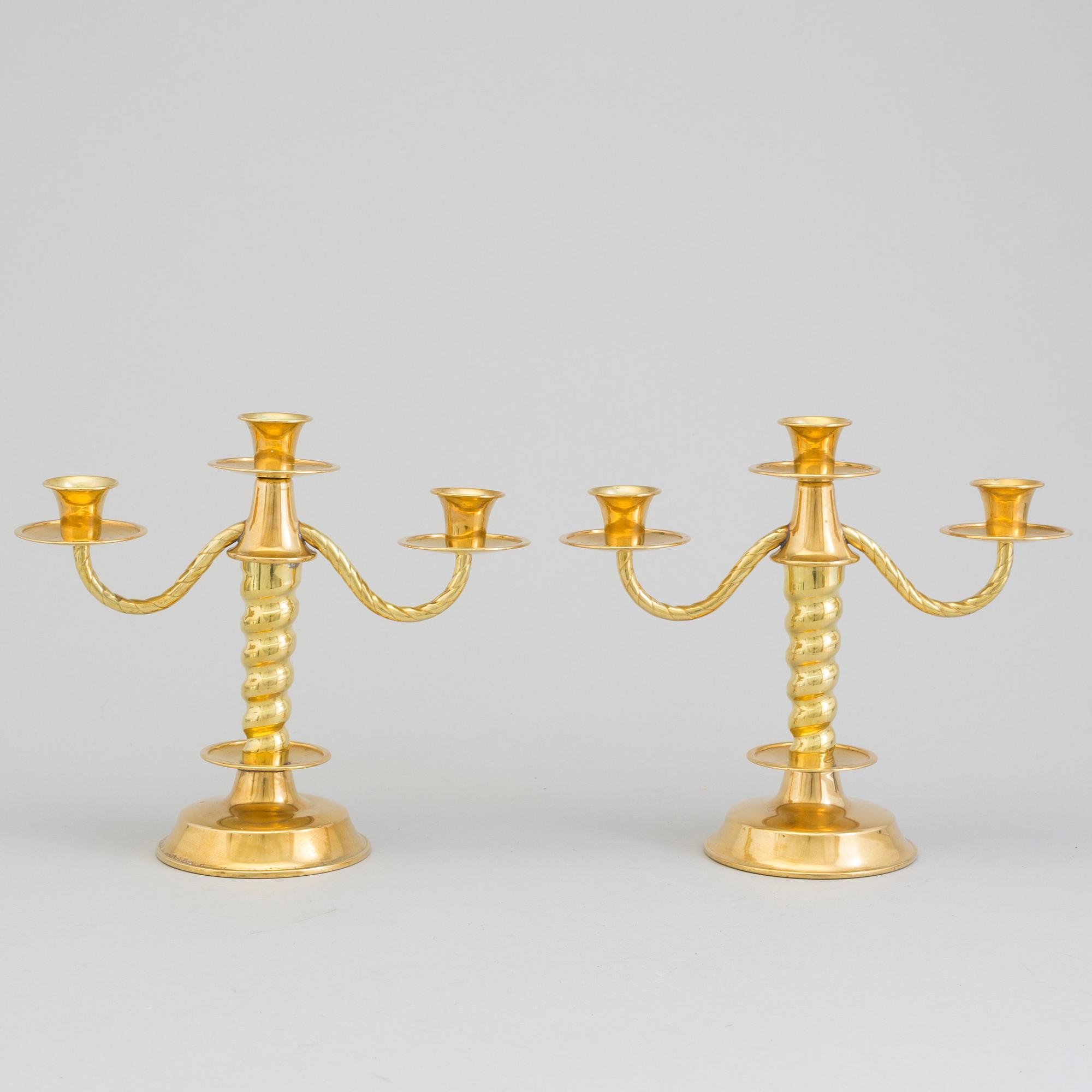 a pair of brass candelabras by Gottfrid Carlsson Eskilstuna.