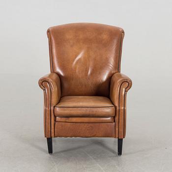 A LEATHER ARMCHAIR.