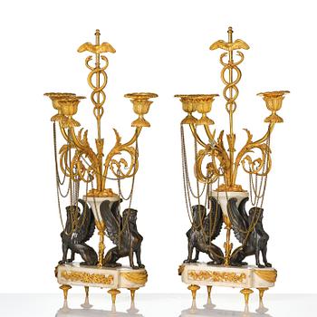 A pair of Louis XVI three lights Candelabra, Parisian works, in the manner of François Rémond, late 18th century.