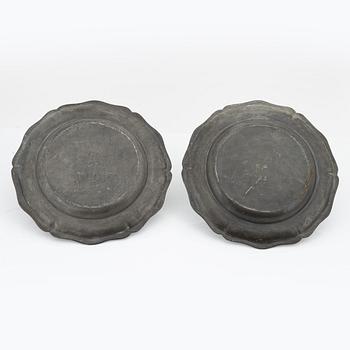 A pair of rococo pewter chargers, mid 18th Century.