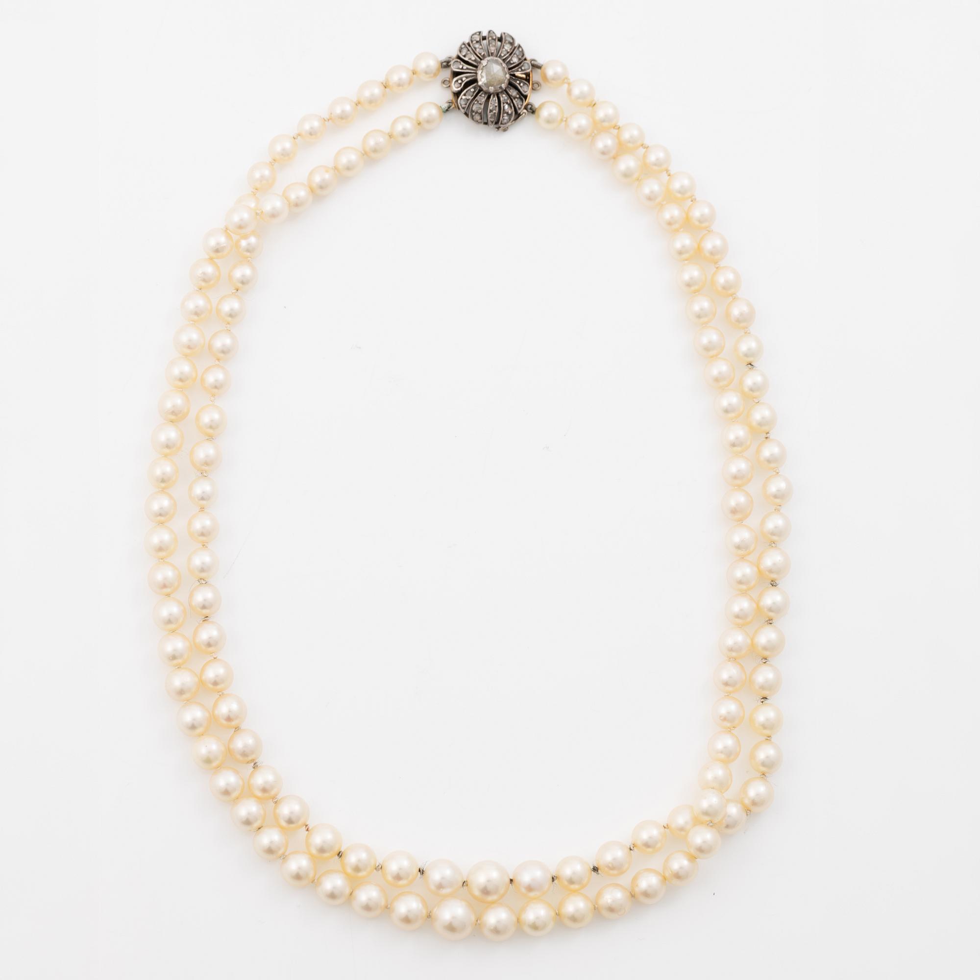 Two-row cultured pearl necklace with a silver and 18K gold clasp set with rose-cut diamonds.