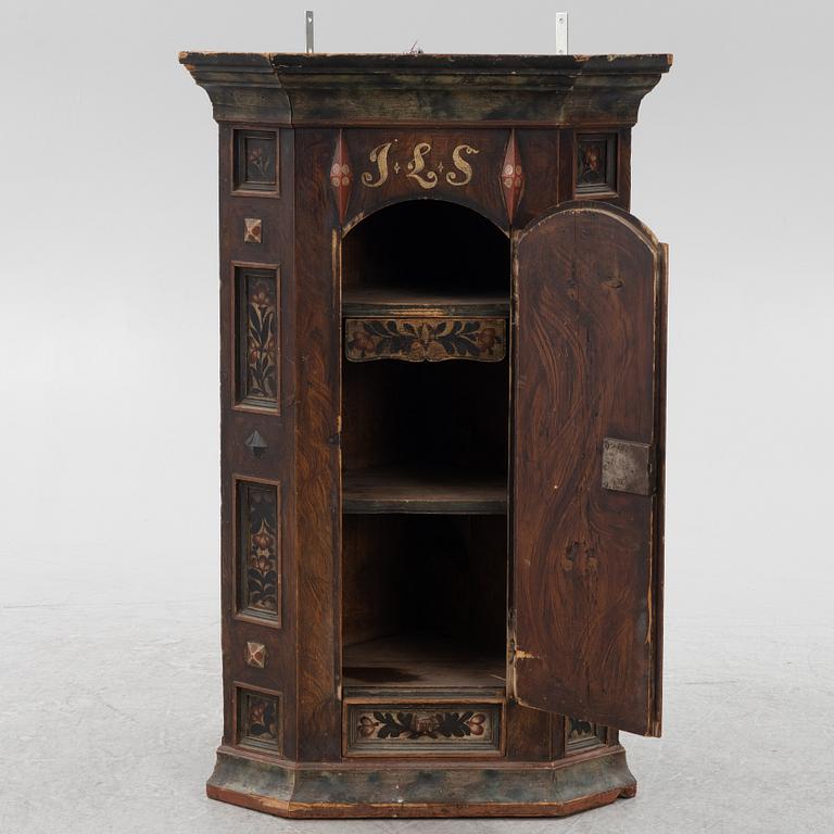 A Swedish painted corner cupboard, 18th Century.