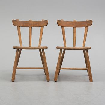 a paor of 1940's pine wood chairs.